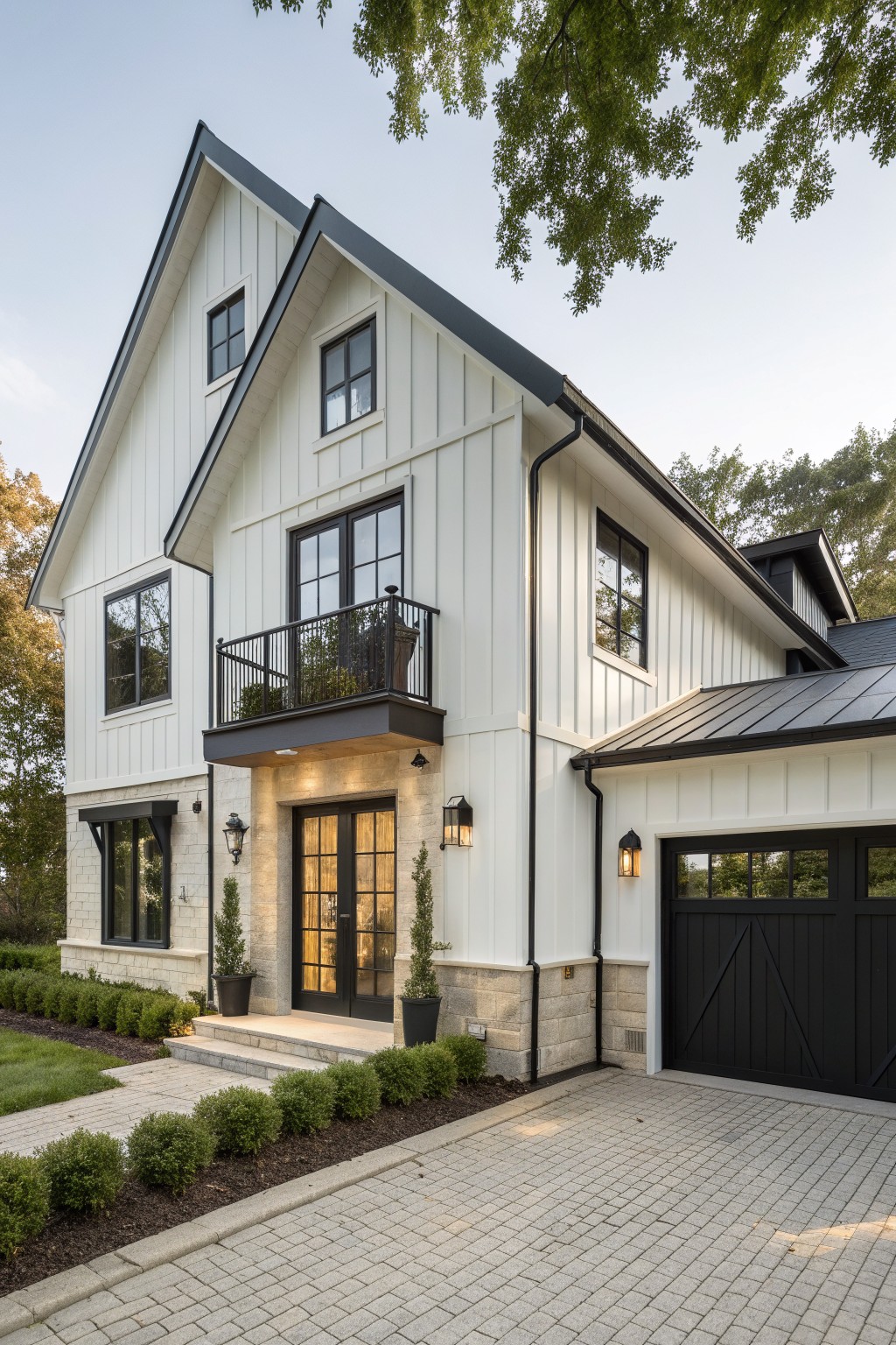 A two-story white modern farmhouse exterior with black window frames, a black garage door, and a small second-floor balcony.