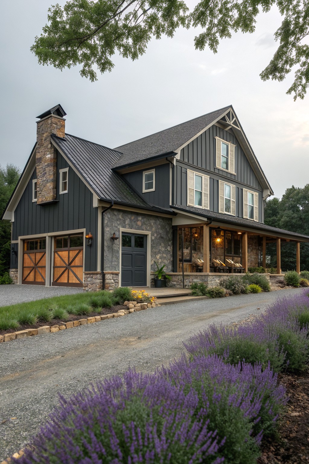 Dark gray modern farmhouse with stone accents, wooden garage doors, and purple flowers.