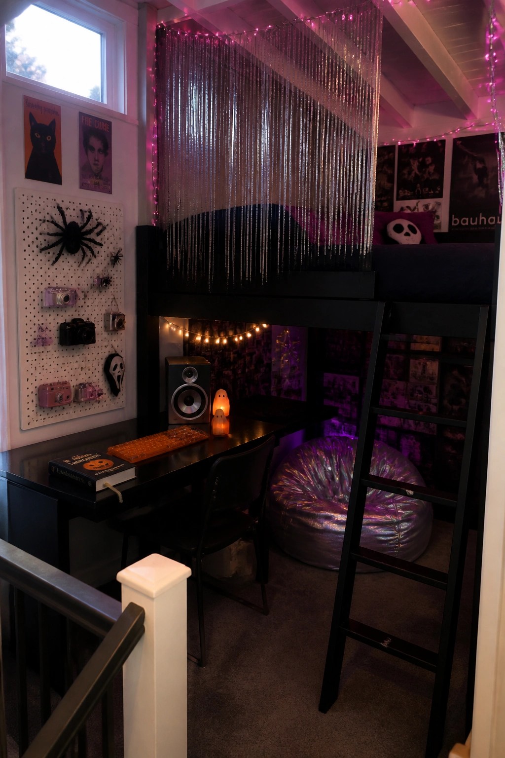 A bedroom featuring a black loft bed over a desk setup with Halloween decorations, a pegboard on the wall, and purple ambient lighting.