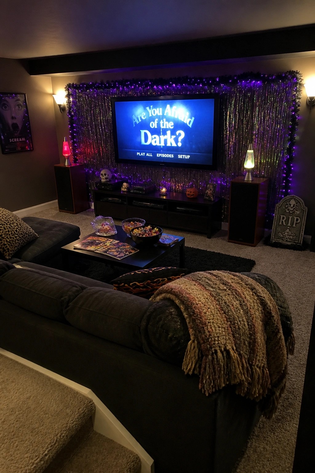 Halloween-decorated living room with TV showing Are You Afraid of the Dark and snacks