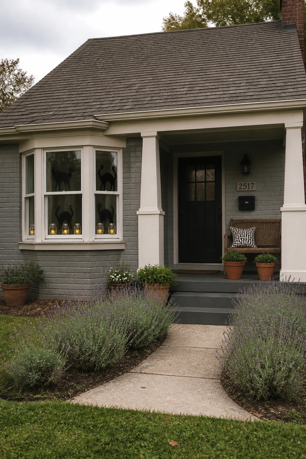 A gray house exterior shows bay windows with black cat silhouettes and glowing jars on the sills, next to a black front door and porch.