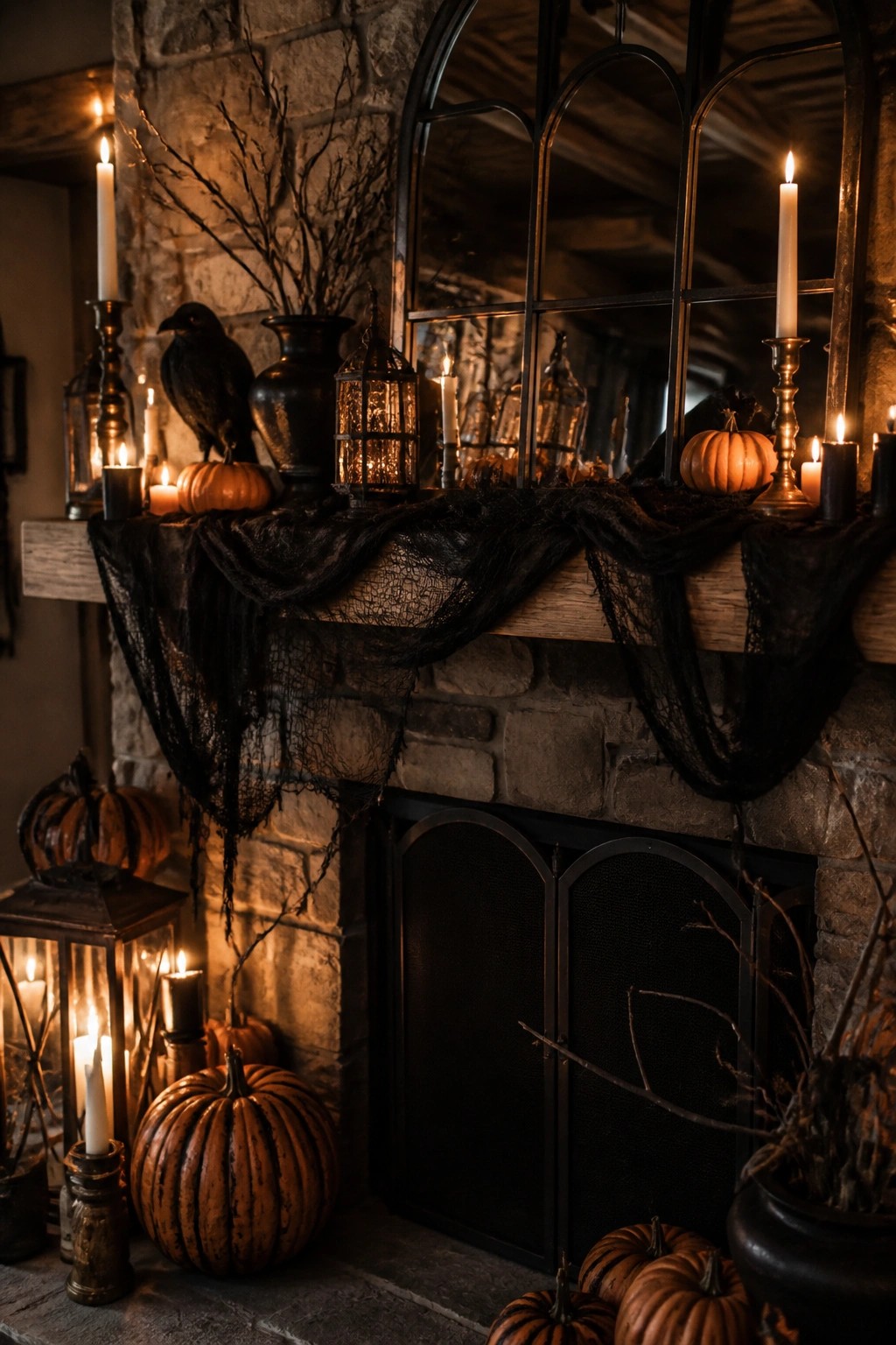 A stone fireplace mantel decorated for Halloween with black lace fabric, orange pumpkins, lit candles, a black crow figure, and lanterns.