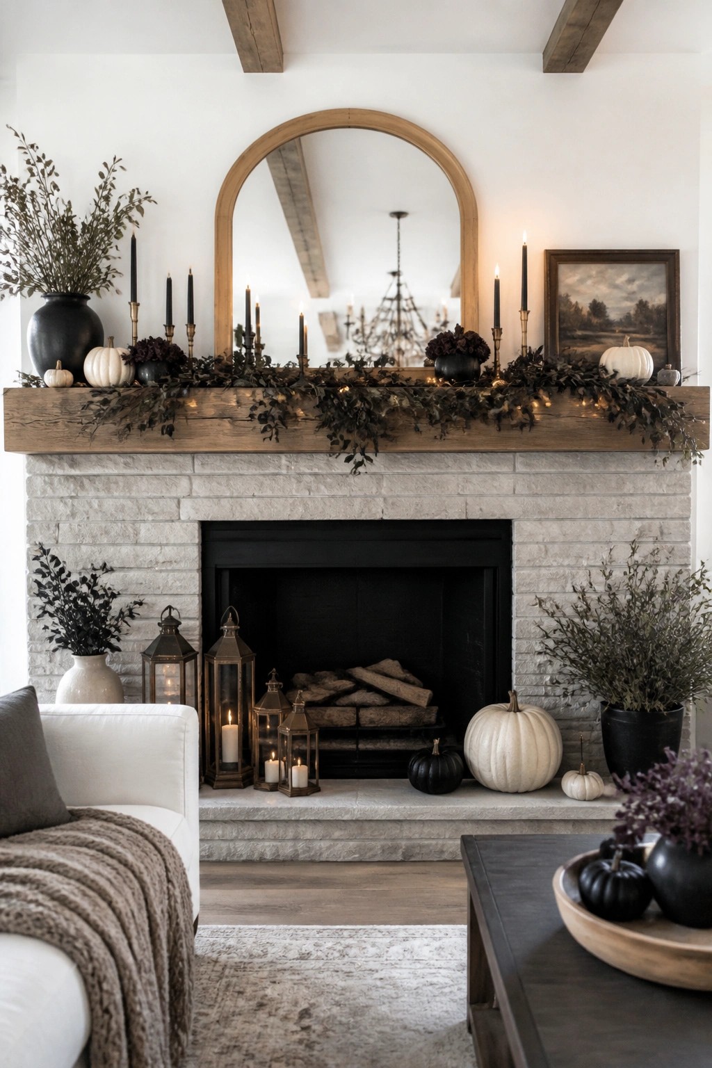 Cozy living room with stone fireplace, autumn garland, pumpkins, and glowing lanterns.