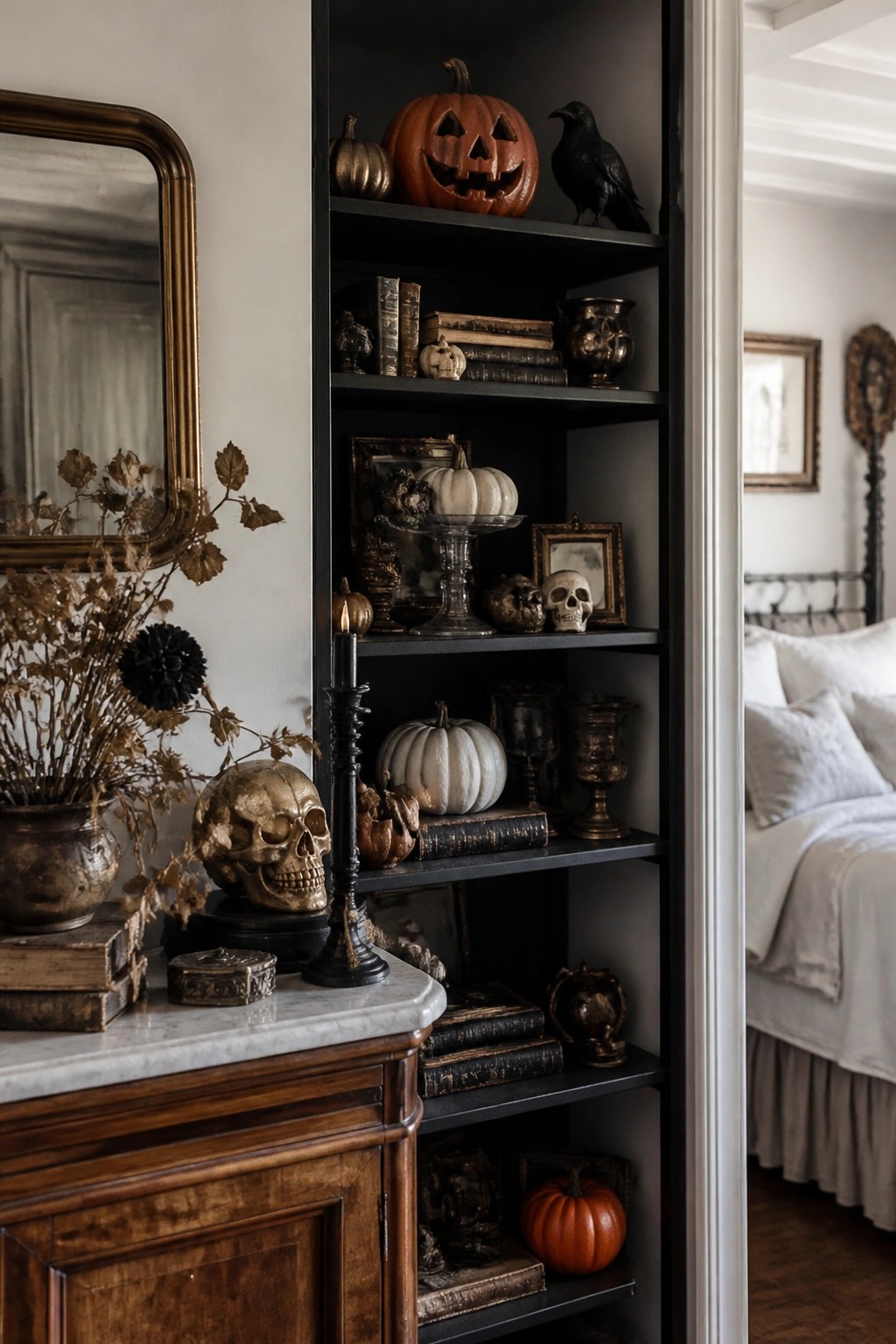 Built-in dark shelves holding carved pumpkins, skulls, old books, and a black crow in a vintage Halloween arrangement.